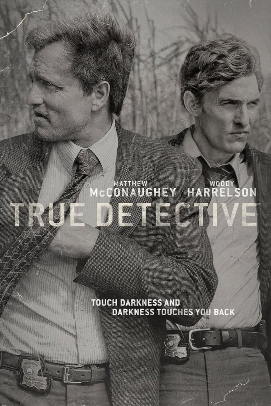 Two serious men in suits stand side by side in tall grass. The text reads: Matthew McConaughey, Woody Harrelson, True Detective. Touch darkness and darkness touches you back. Black and white, gritty style—an atmosphere as intense as streaming True Detective on IPTV Netherlands.