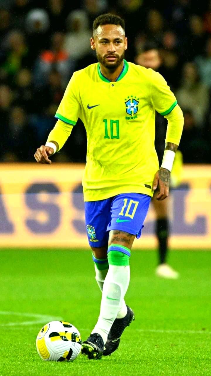 A soccer player in a yellow Brazil jersey with number 10 is dribbling a ball on the field during a match, as fans enjoy the thrilling action through IPTV Netherland.